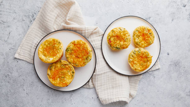 istock Savory muffins with egg, feta cheese, cheddar and spinach on light background 2190809206
