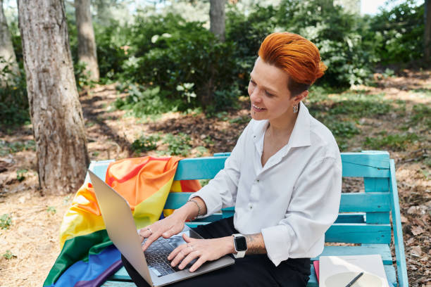 istock Young teacher engaged in remote work while enjoying nature and vibrant colors in a park setting 2190809263
