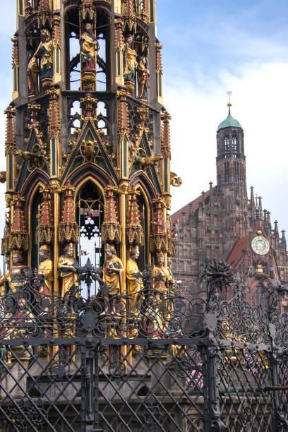 Nuremberg, Germany - December 15, 2013: Decorated fountain in the market square and church