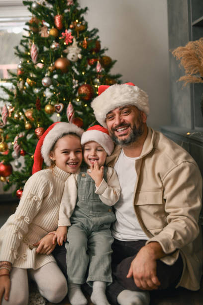 istock Joyful Father and His Two Children Creating Memories Under Christmas Tree 2190809559