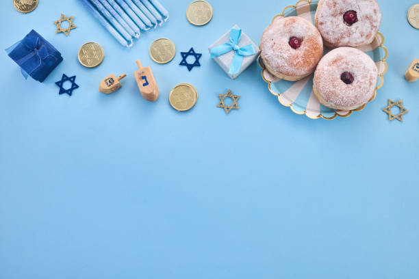 istock Hanukkah Celebration frame. Festive Hanukkah items on blue background 2190810404