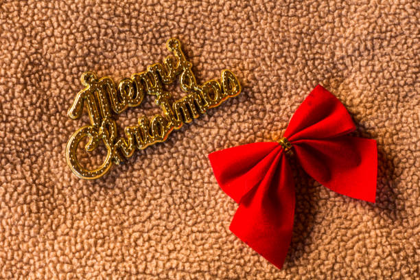 Merry christmas word with bow on fabric christmas still life