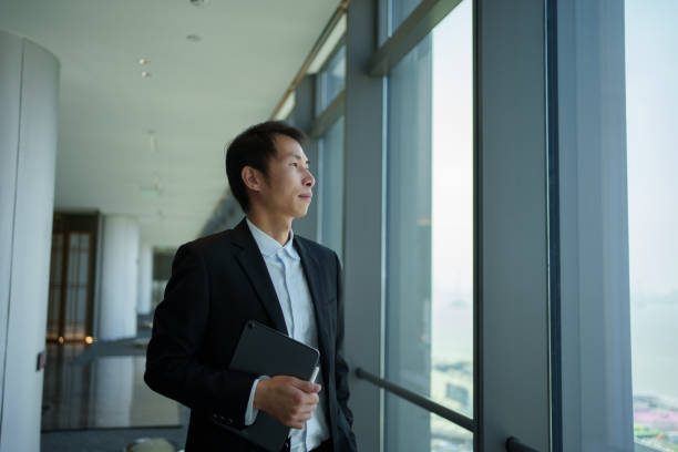 istock Business man looking out the window 2190812232