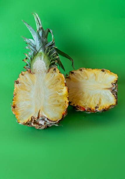 Pineapple isolated on green background with copy space for text. Minimalist