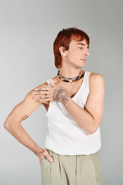 istock Young man showcasing modern fashion with confidence in a minimalist setting 2190825334