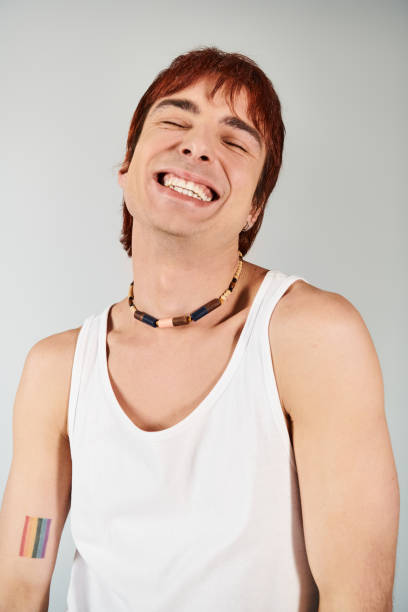 istock Young man showcasing modern fashion with a joyful smile in a vibrant studio setting 2190825347