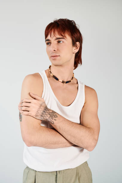 istock Young man showcasing modern fashion with confidence and elegance in a minimalist setting 2190825352