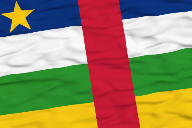 The national flag of the Central African Republic, featuring four horizontal stripes of blue, white, green, and yellow with a vertical red stripe and a yellow star in the top left corner, is shown waving in the wind. The textured fabric conveys movement and symbolizes unity and national pride.