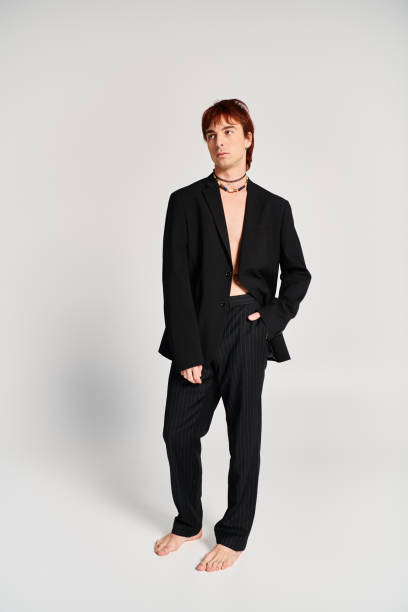 istock Fashion forward young man showcases striking style in minimalist studio setting 2190825413