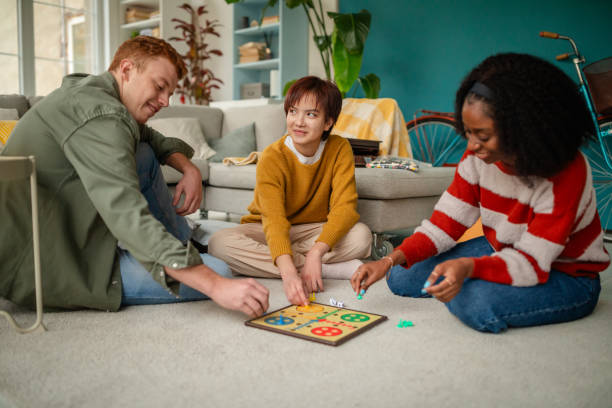 istock Three friends enjoying a board game together indoors. 2190826259