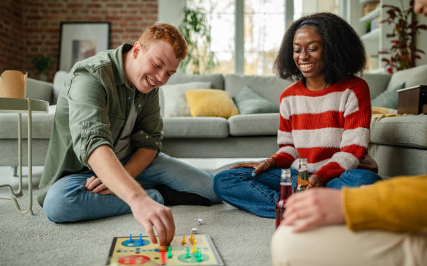istock Three friends in heated board game competition at home. 2190826773