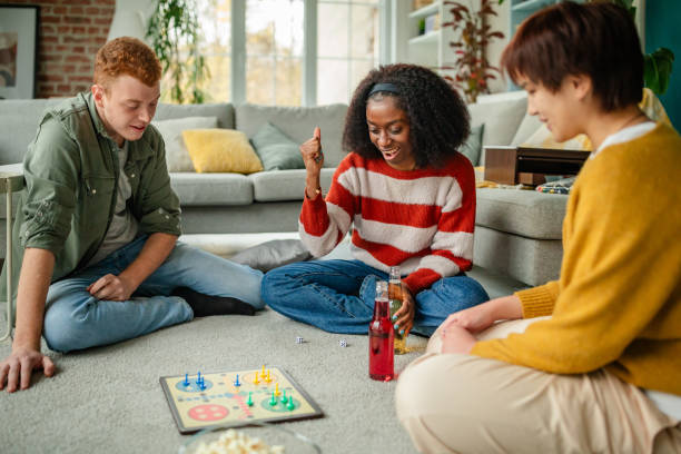 istock Friends playing board game on living room floor 2190826793