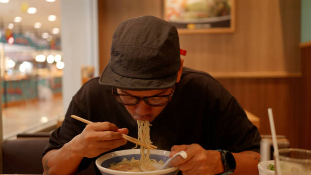 istock Asian hungry man eating noodle ramen. 4K. 2190827954