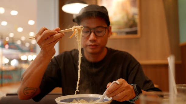 istock Asian hungry man eating noodle ramen. 4K. 2190827961