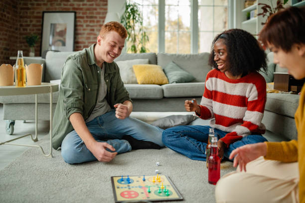 istock Joyful group celebrates winning move in board game. 2190830035