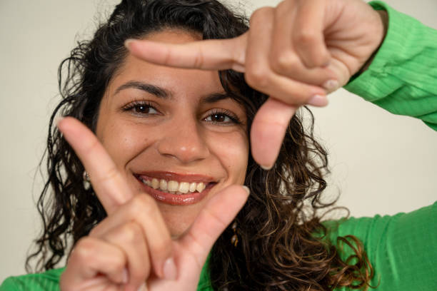 istock Young woman making a frame with her fingers and smiling 2190830139