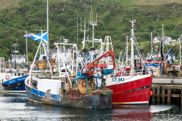 stern end of a fishing vessel showing fishing nets and rigging stowed on drums, at the ferry port of Mallaig, Lochaber, Inverness-shire