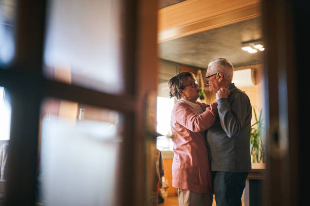 Senior couple dancing in their cozy home
