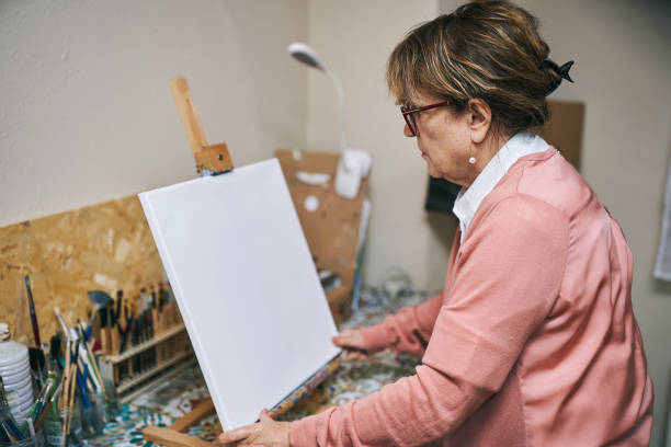 istock Senior woman preparing canvas for painting 2190830707