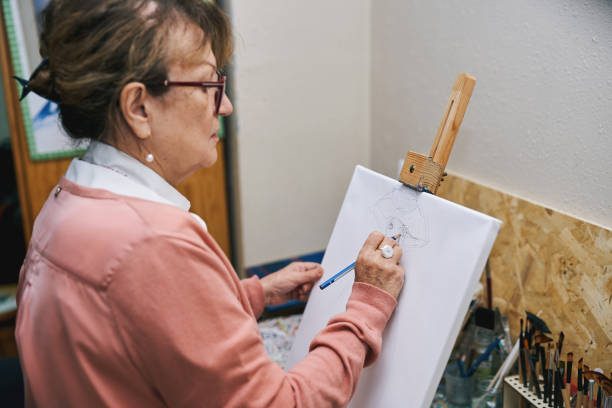 istock Senior woman sketching on canvas 2190830713