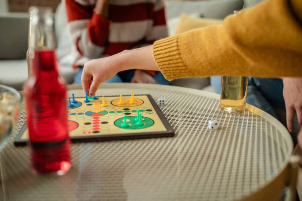 istock Hand placing piece on board with colorful game parts. 2190830836
