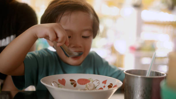 istock Asian boy eating noodle. 2190831146