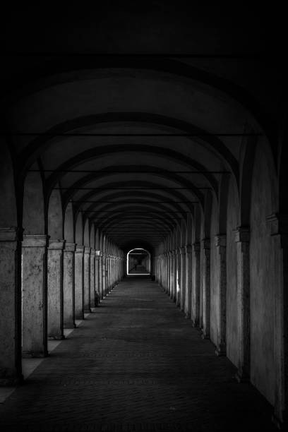 istock Dark tunnel perspective. Grunge architecture, old corridor in shadow. 2190832811