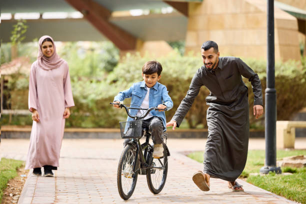 istock Boy is learning to cycle on footpath at park 2190832854