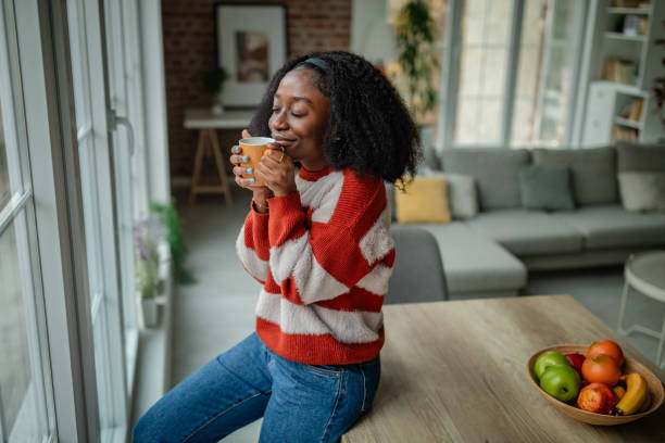 istock Woman enjoying coffee, smiling with eyes closed. 2190832927