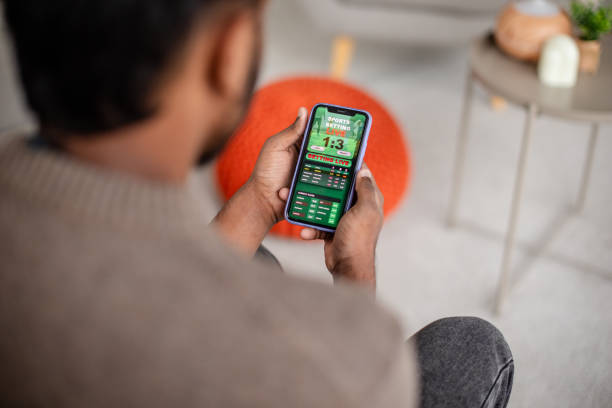 istock Man checking sports results on mobile device screen 2190834249