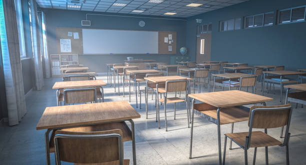 Empty classroom with wooden desks and chairs awaiting students