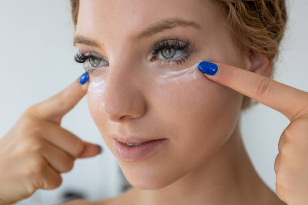 istock Female apply cream on under eye 2190835538