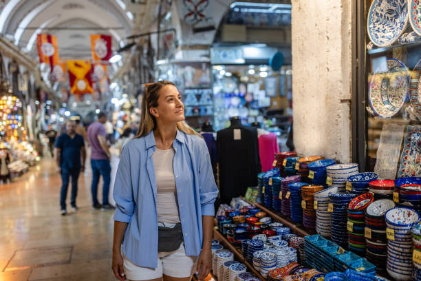 istock Woman explores vibrant market with pottery display. 2190836168