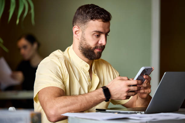 istock Male entrepreneur using smart phone at office 2190836309
