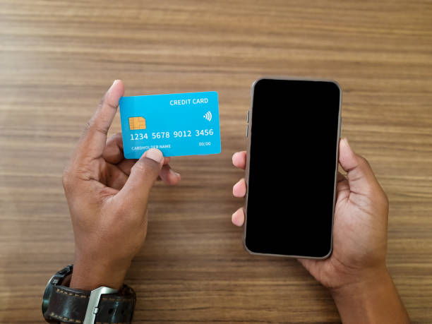 istock Man Holding Credit Card and Smartphone 2190836802