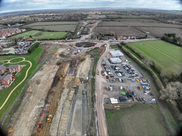 istock Aerial view of construction site amid fields and homes. 2190838576