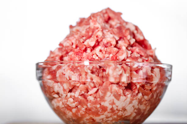 Minced Meat in Bowls on Wooden Surface.