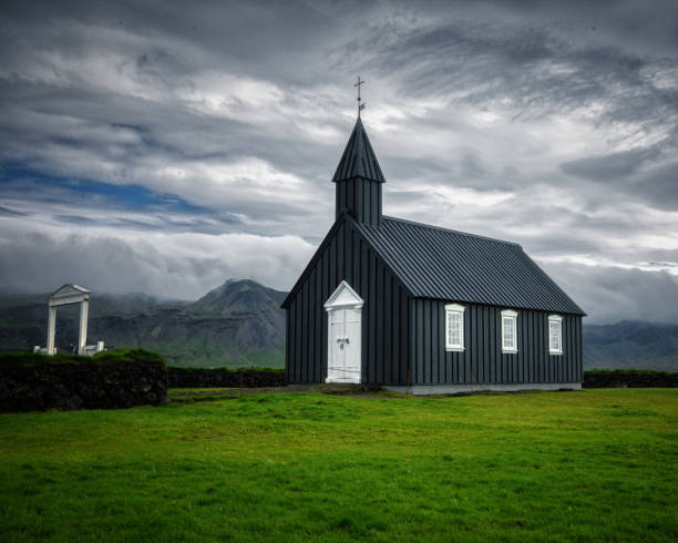istock Church Surrounded by Dramatic, Cloudy Skies in Iceland 2190839153
