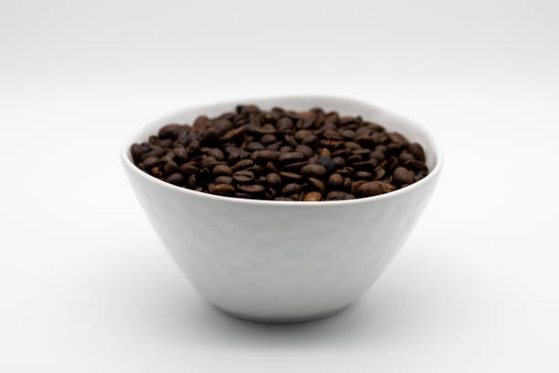 istock Bowl of Freshly Roasted Coffee Beans on White Background. 2190839711