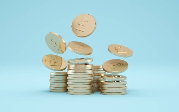 istock Pound Gold Coins on Blue Soft Infinite Background 2190840742