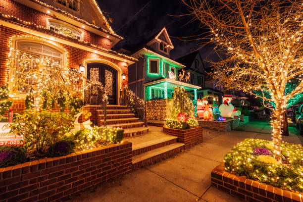 McAdenville, North Carolina, USA - December 1, 2014: The quiet little town of McAdenville, which lies along the South Fork River in Gaston County N.C., comes alive in spectacular fashion each year as Christmas draws near. Almost overnight, the small textile town is transformed into “Christmas Town, USA.” A tradition since 1956, Victorian-style, brick and wood sided homes are beautifully and tastefully decorated for the Holiday Season. Taken just before sunset to include a beautiful and colorful sky as a backdrop to this festive image.