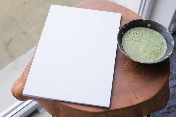 istock blank magazine mockup on coffee table with green matcha tea near window 2190841993