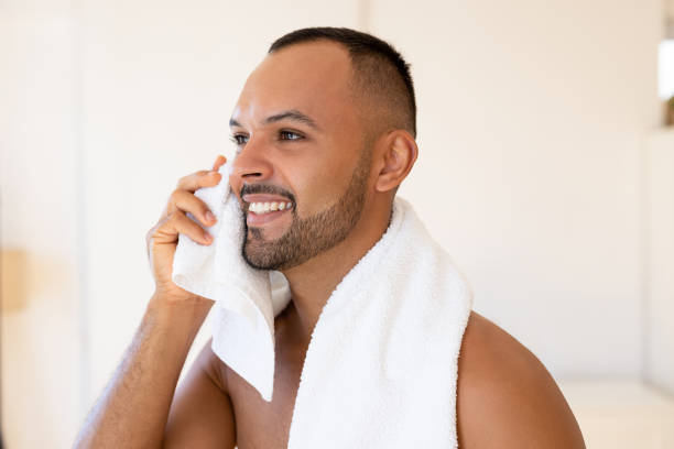 istock Handsome male wipes his face with towel 2190843128