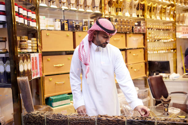 istock A Middle Eastern man is choosing wooden oud incense from a shop display. 2190843747