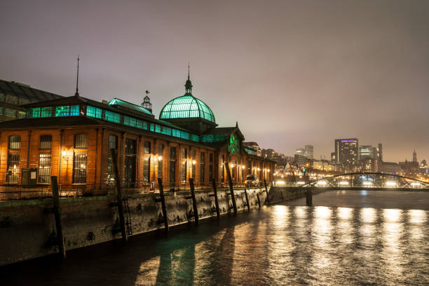 Hamburg, Germany - December 14, 2024: Fischauktionshalle in Hamburg, a famous landmark of the city, illuminated in the night.
