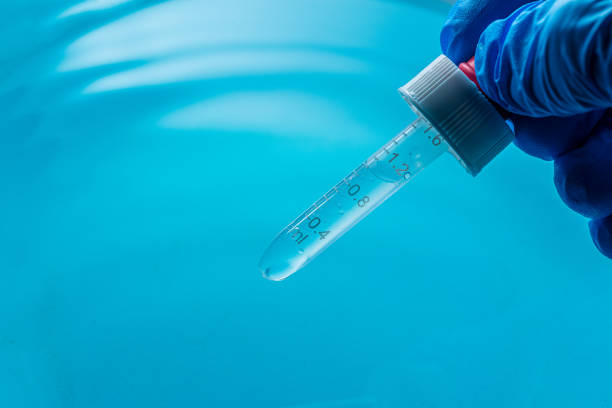 istock Blue Science Test Tube Macro,Test tube with formula inside in arm. Macro image with selective,Test tubes in blue tone. 2190850799