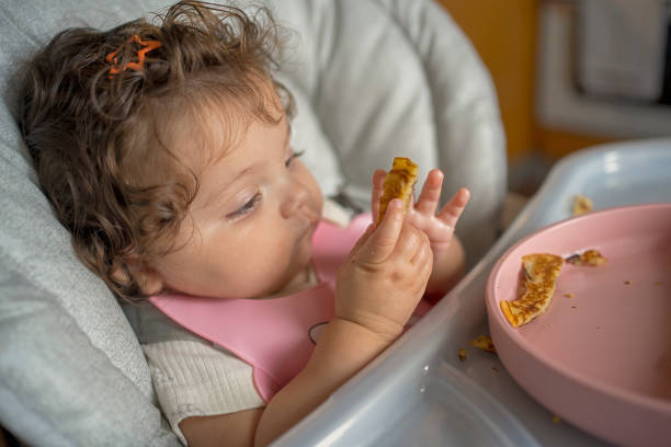 istock Baby Exploring Food in a High Chai 2190851574