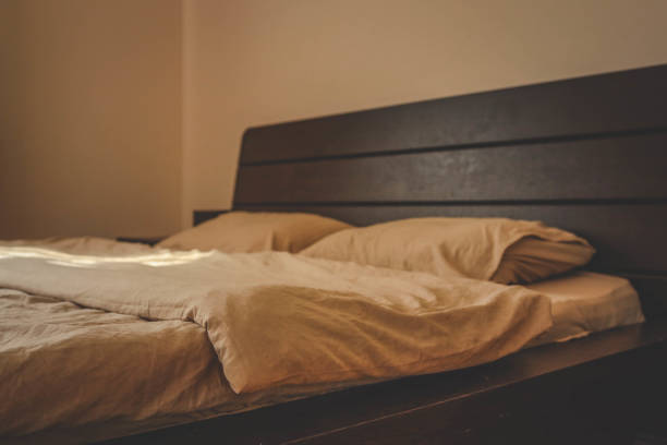 Cozy beige bedding on the bed.