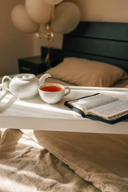 istock Open Bible and cup of tea, morning prayer concept 2190851913