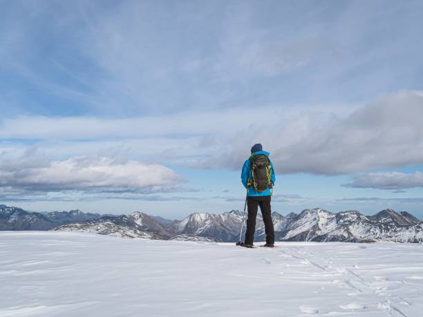 istock Hiker Admiring Snowy Peaks on Mont Chaberton 2190853470